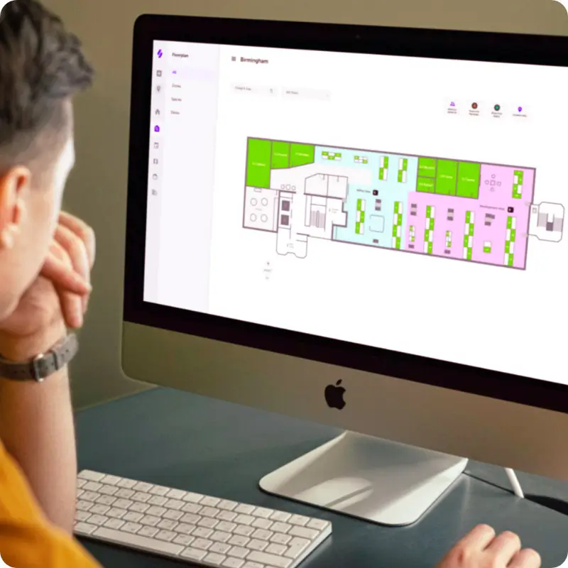 Workspace Management - man working on floorplan using a Mac