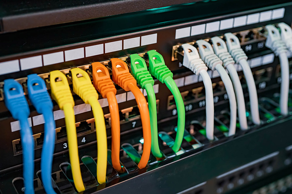 Colourful ethernet cables plugged into hardware