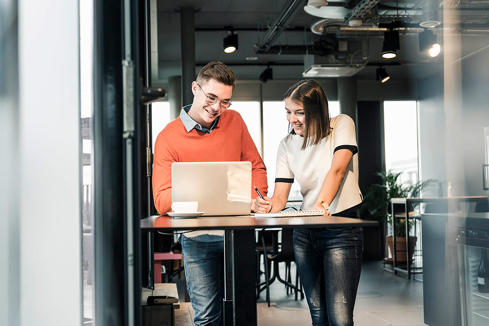 Casual business man and woman with laptop in meeting