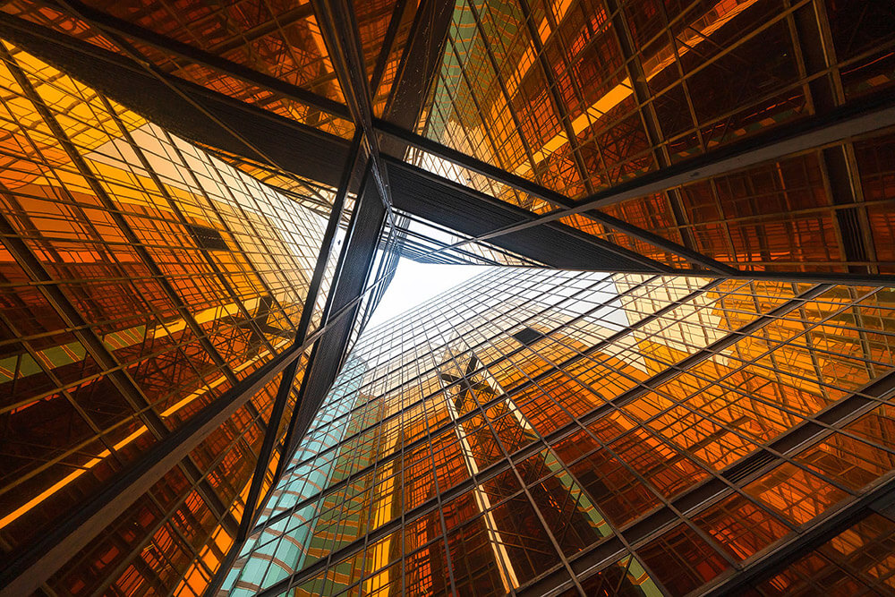 Looking up through glass office building architecture