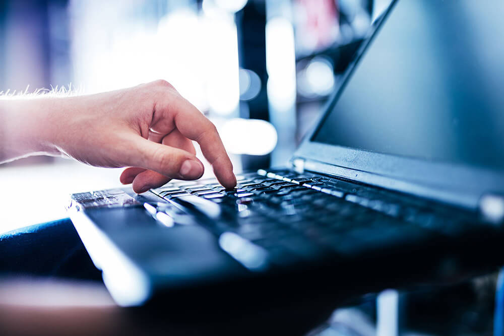 IT specialist pressing button on keyboard