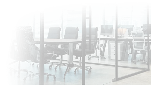 Modern office space with empty chairs and tables, glass partitions.