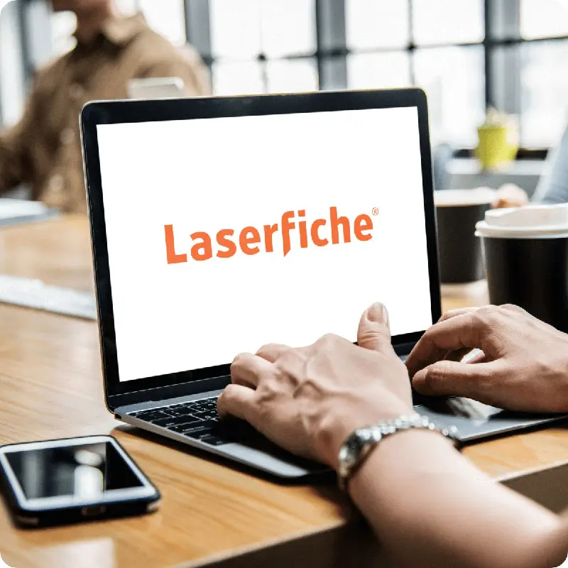 Person using laptop with Laserfiche logo displayed